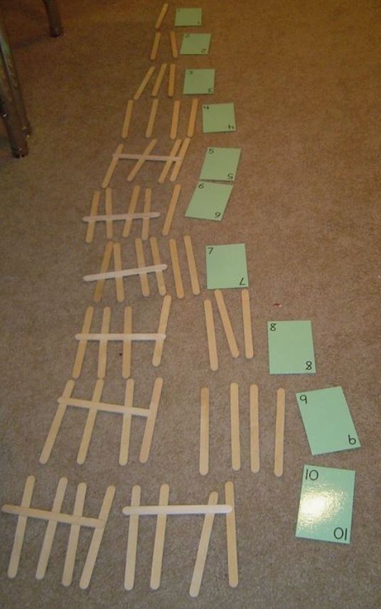 several pieces of paper laid out on the floor next to each other with pins stuck in them