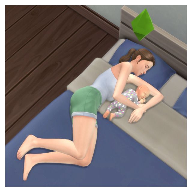 a woman laying on top of a bed next to a baby in a diaper