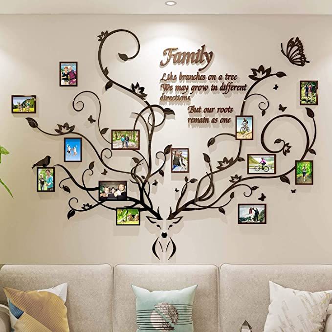 the family tree wall decal is shown in this living room with many pictures on it