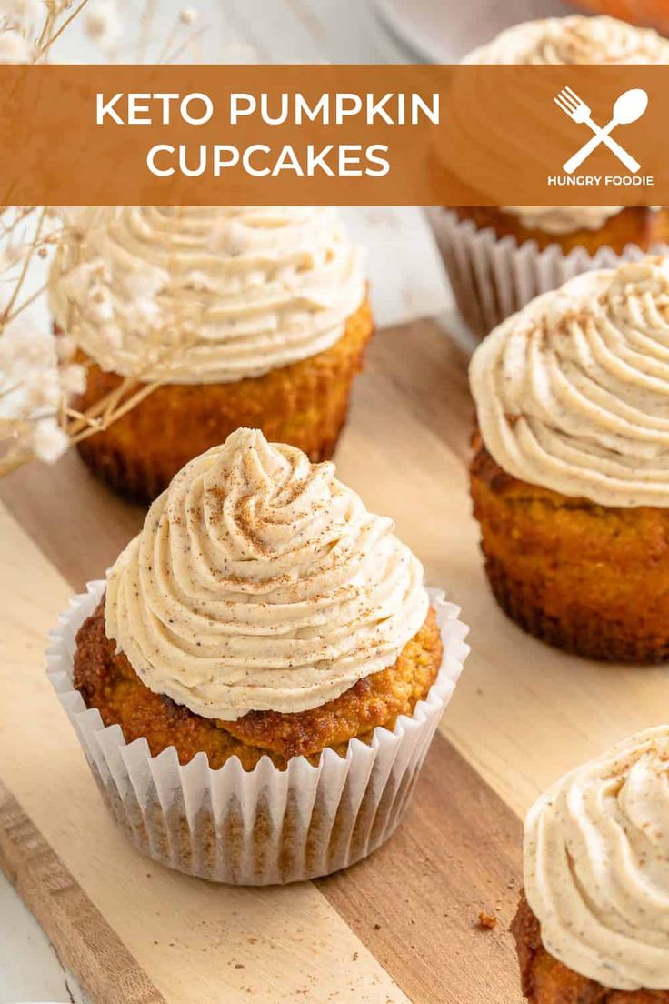 several cupcakes with frosting on top sitting on a cutting board next to some forks