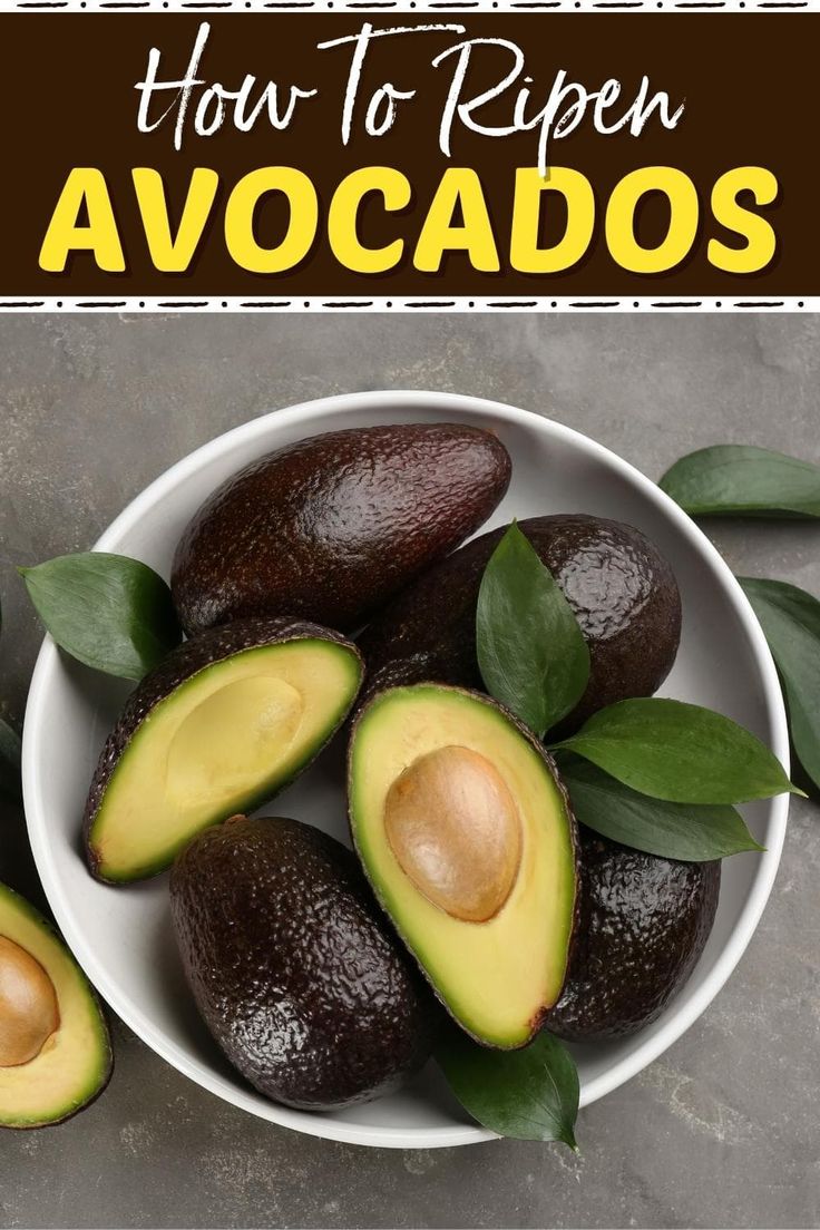 avocados in a bowl with leaves on the side and text overlay how to ripen avocados