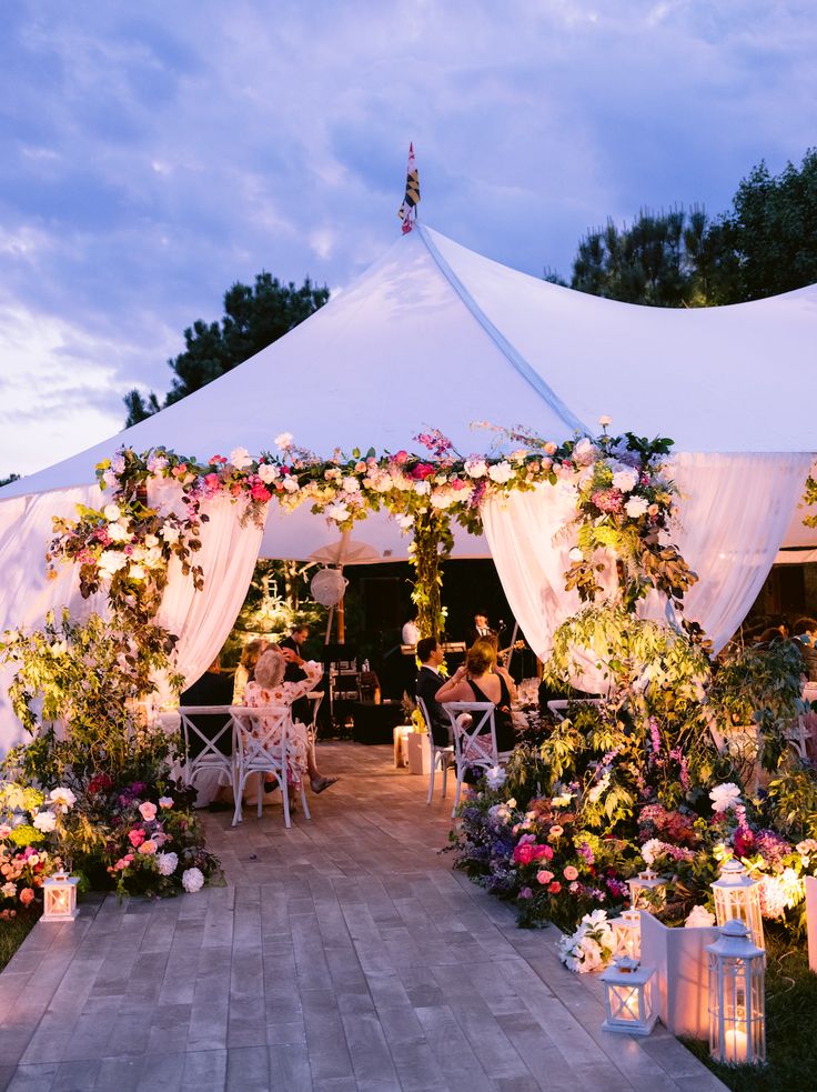 a white tent with flowers and candles on it