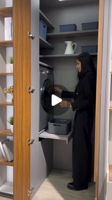 a woman in a black robe is opening a dryer