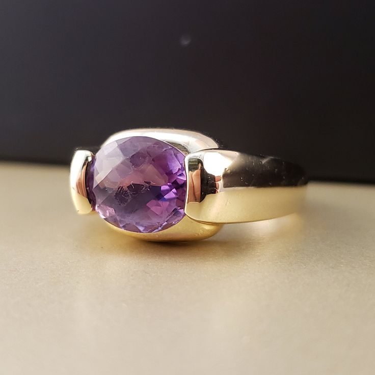 "\"Previously Loved, Not New\" Vintage Amethyst Ring, Featuring a Genuine Amethyst center (*Price of the ring is really gold only. The center is pretty scratched on the surface.*) This Genuine Purple Amethyst center stone is a checkered board cut oval shape. 14k Yellow Gold setting with 2 heavy bars. **Ring size: 6.25 **Amethyst is February's Birthstone, AND 2018 color of the year. This item can be sized up or down 2 sizes for an additional $30.00 Please feel free to contact me anytime, if you h Vintage Amethyst Ring, Checkered Board, Amethyst Rings, Amethyst Ring Vintage, Ring Purple, Lapis Ring, Rings Vintage, Yellow Gold Setting, Purple Band