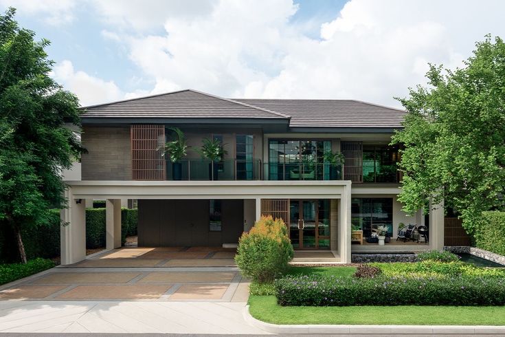 a large house with lots of trees and bushes in front of the entrance to it