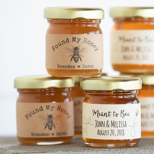 four jars of honey with labels on them