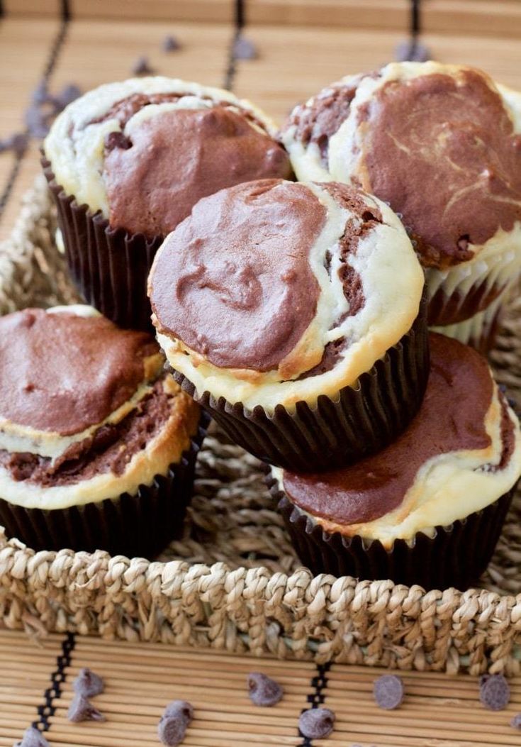 chocolate cupcakes with white frosting in a wicker basket