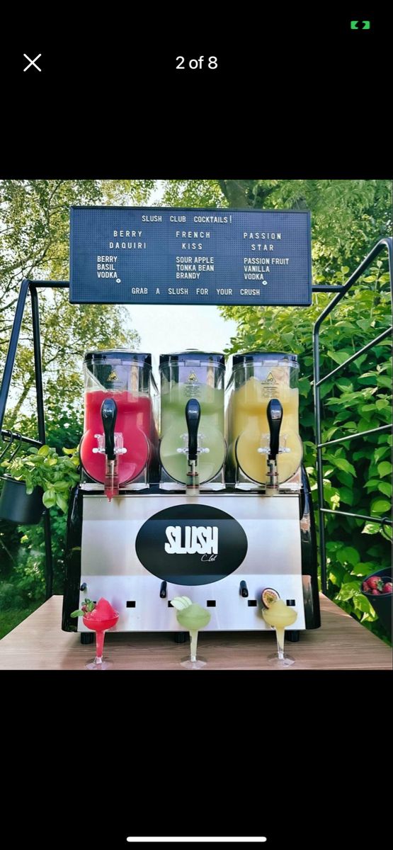 the slushy machine is filled with different drinks