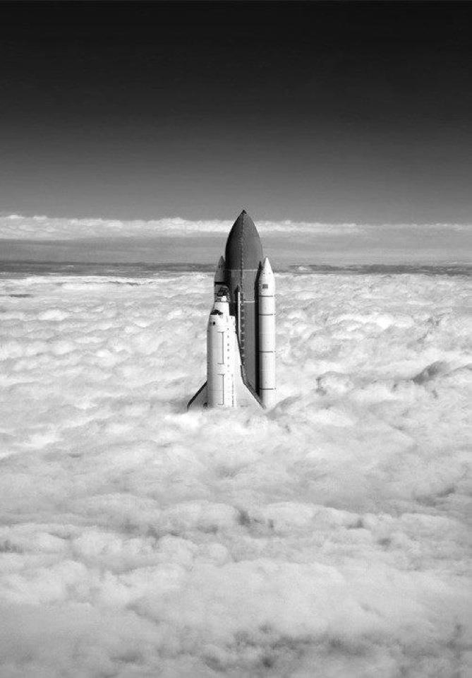 a space shuttle is flying through the clouds