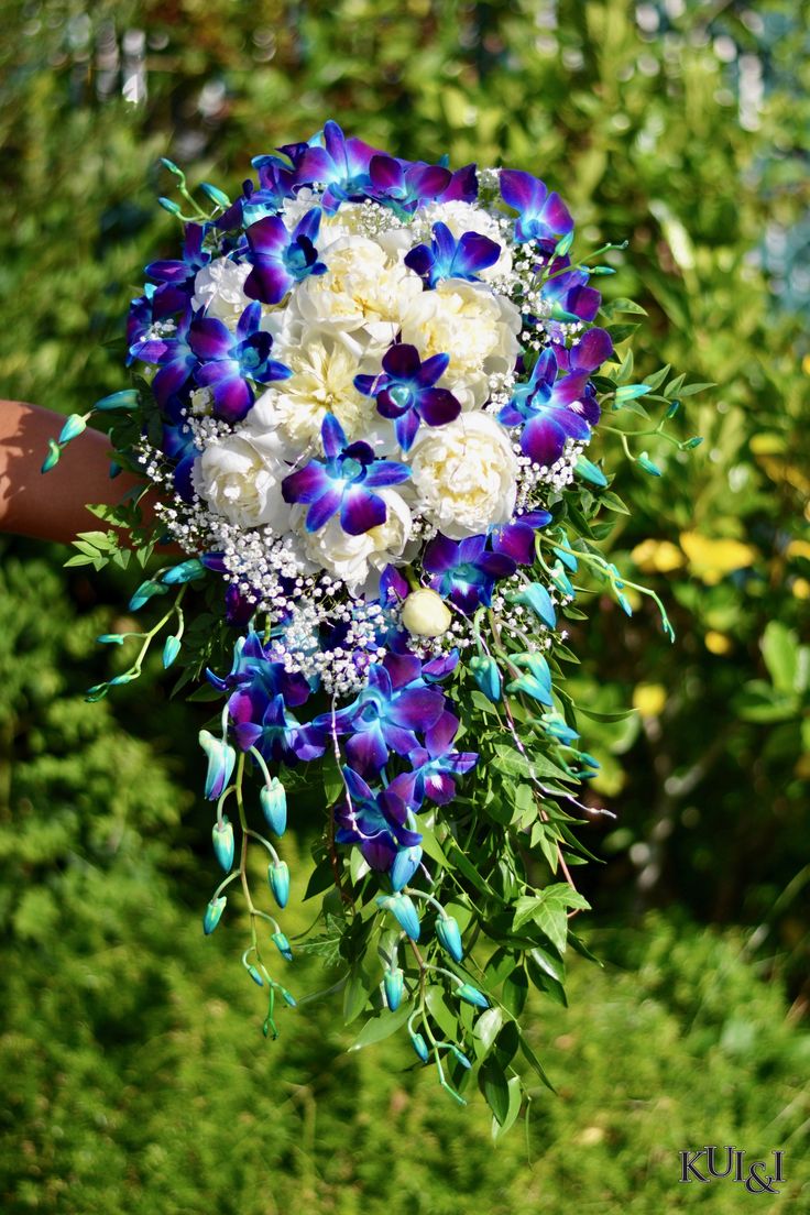 a bridal bouquet with blue and white flowers