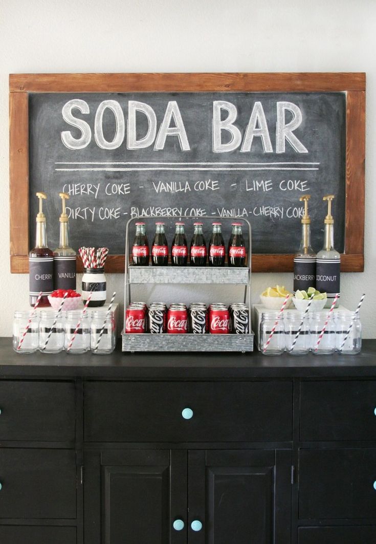 an image of a bar with sodas on it and the words soda bar written in chalk