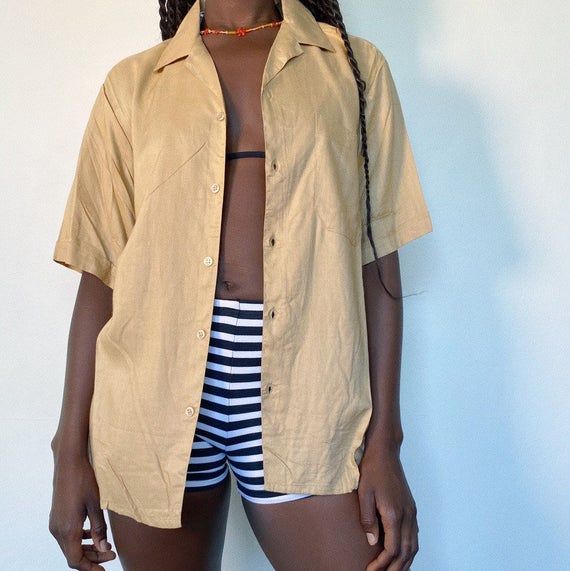 90s button up shirtThe trend for summerr! Wear it open, half done up with a mini skirt or tied up with some high waisted jeans.In a light weight material, beige is also a colour that you can match with everything! ..No marked size Modelled on a size 8...#buttonup #shirt #90s #y2k Women’s Button Up Shirt, Beige Camp Shirt For Spring Vacation, Summer Button Up, Beige Collared Shirt For Summer, Beige Collared Summer Shirt, Beige Camp Shirt For Beach And Summer, Summer Vacation Beige Camp Shirt, Beige Summer Shirt With Button Closure, Beige Button Closure Shirt For Summer