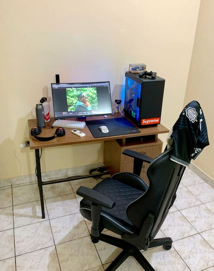 a chair sitting in front of a desk with a computer on it