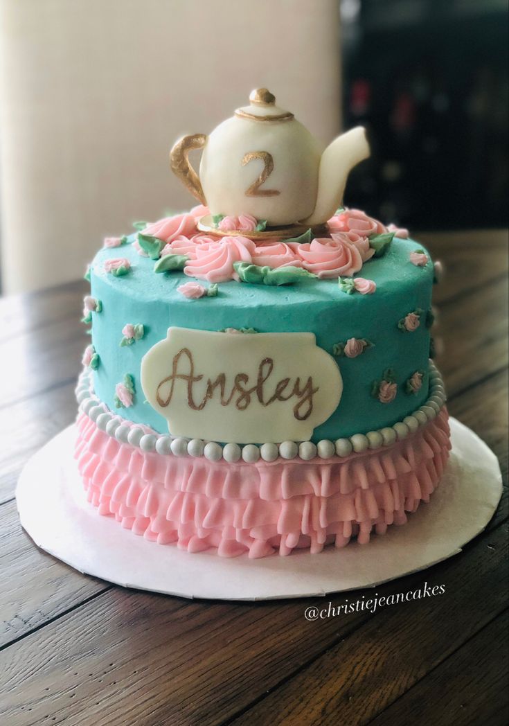 there is a cake with a teapot on top