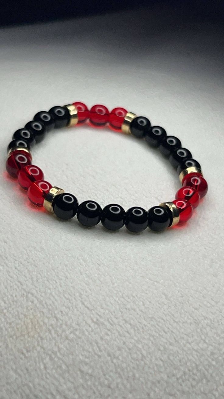 Red and Black Bracelet with Gold accents  7.5 in or 19.05 cm round Strong, Stretchy, and Durable Pretty bracelet for any occasion for any day Black And Red Beaded Bracelets, Elegant Red Stretch Bracelet With 8mm Beads, Red Stretch Bracelet With Black Beads, Casual Red Beaded Bracelets With Black Beads, Red Stretch Bracelet With Black Beads As A Gift, Casual Red Wristband With Round Beads, Red Bracelets With Black Round Beads, Casual Red Bracelets With 8mm Beads, Casual Red Bracelets For Party