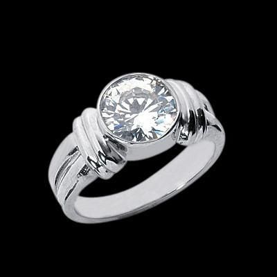 a white gold ring with a round cut diamond in the center on a black background