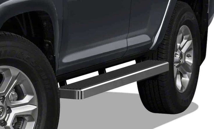 the side view of a gray truck with chrome rims