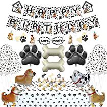 an image of a birthday party with dogs and bones on the tablecloth, balloons, and decorations