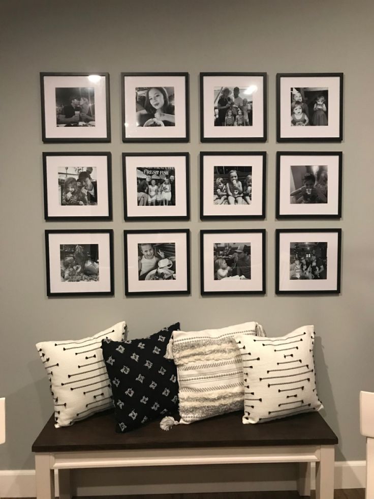 a bench with pillows and pictures on the wall