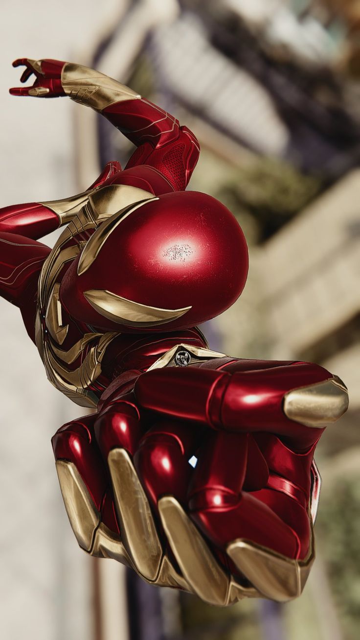 a close up of a red and gold iron man statue in the shape of a hand