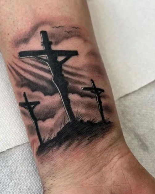 a man's foot with a cross tattoo on it