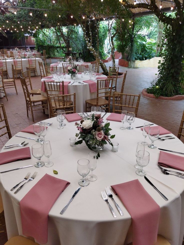 the tables are set with pink and white linens