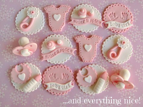 some pink and white decorated cookies on a table