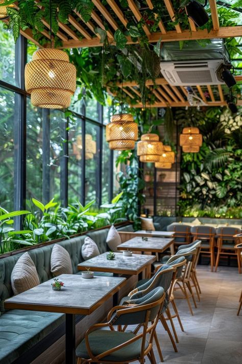 an indoor restaurant with tables and chairs covered in plants