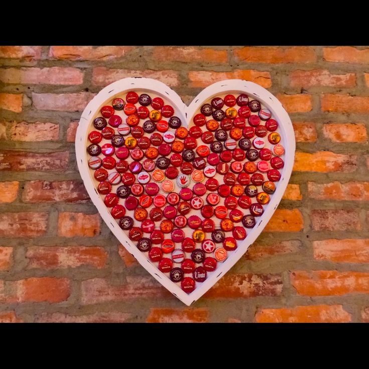 a heart made out of buttons on a brick wall