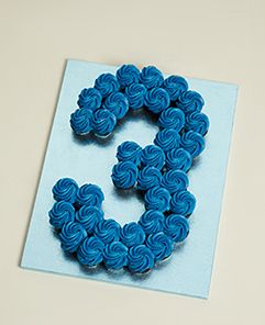 there is a blue brooch that looks like the letter c on top of a card