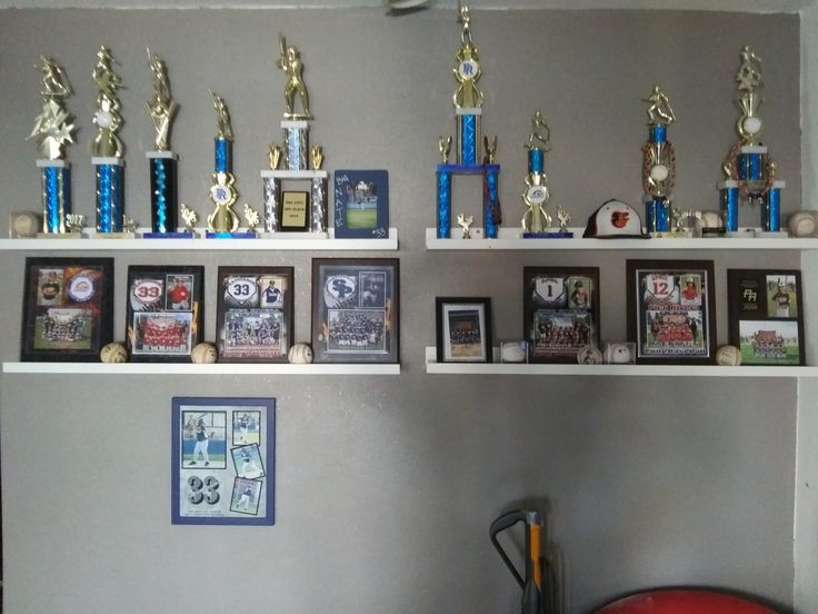 there are many trophies on the shelves in this room