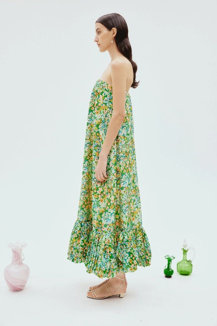 The Francis Bubble Midi Dress comes in a stunning green color with small floral detailing, designed to make a statement at your next garden party. This strapless A-line dress features a voluminous bubble hem that adds a playful flair to its elegant midi length silhouette. With a structured internal corset featuring boning for a flawless fit, this dress is as flattering as it is chic. Fully lined for added luxury, the Francis Bubble Midi Dress is your go-to for a bold yet refined look at any spec