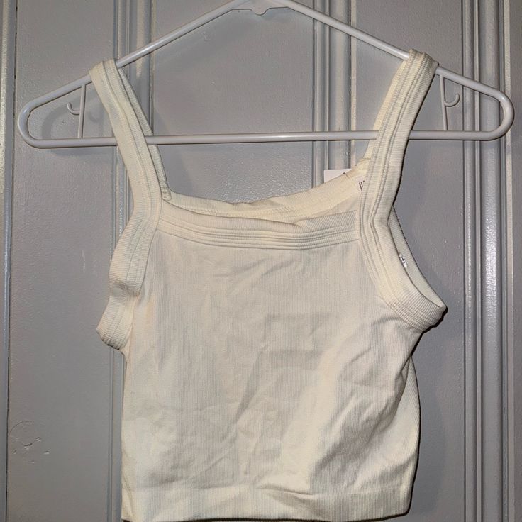 Brand New With Tags Out From Under Baby Tank Size Is Xs/Small Urban Outfitters Fitted Cropped Tank Top, Fitted Urban Outfitters Tank Top For Spring, Urban Outfitters White Tank Top For Day Out, Urban Outfitters Cropped Tank Top For Spring, Urban Outfitters White Crop Top For Day Out, Urban Outfitters White Fitted Crop Top, Fitted White Crop Top From Urban Outfitters, Fitted White Crop Top By Urban Outfitters, Baby Tank