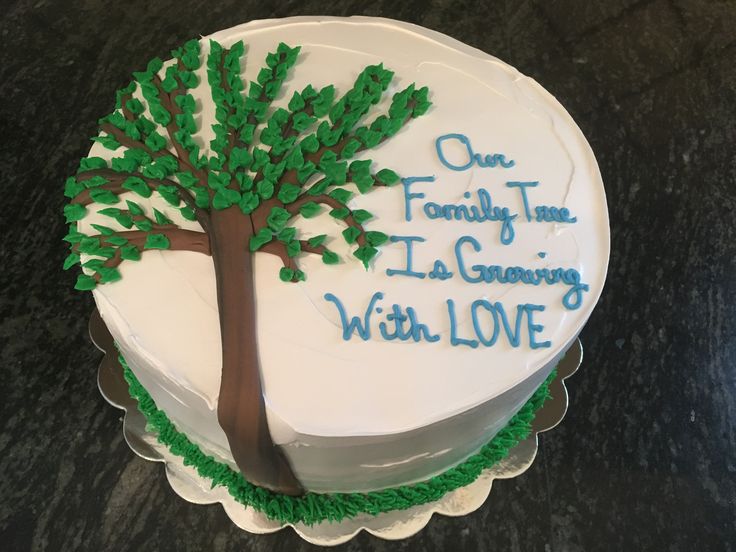 a white cake with green frosting and a tree on top that says, one family time it's growing with love