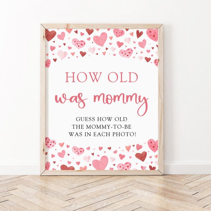 a wooden sign with hearts on it that reads how old was mommy? guess how old the mommy - to - be was in each photo