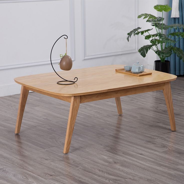 a wooden table with a metal ball on top