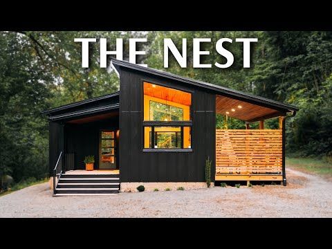 a small black cabin with the words the nest above it