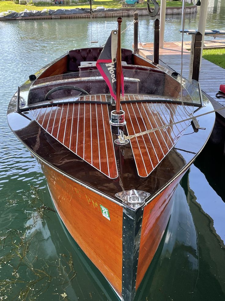 a small wooden boat docked in the water