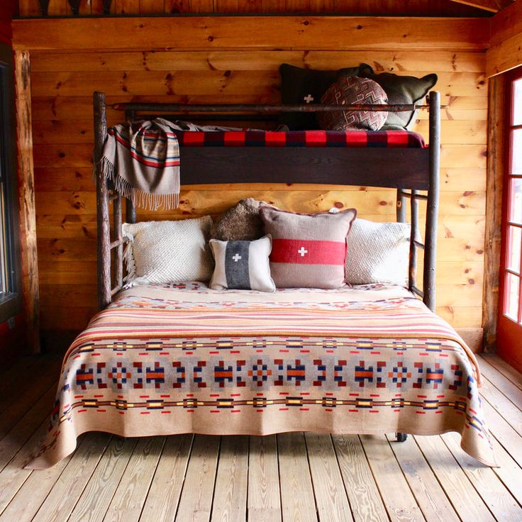 a bed in a room with wooden walls