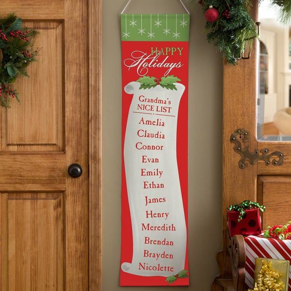 a christmas banner hanging on the wall next to a door with presents in front of it