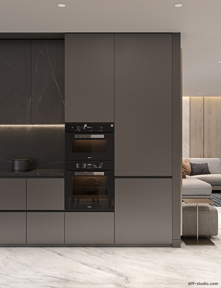 a modern kitchen with marble counter tops and grey cupboards, along with an oven