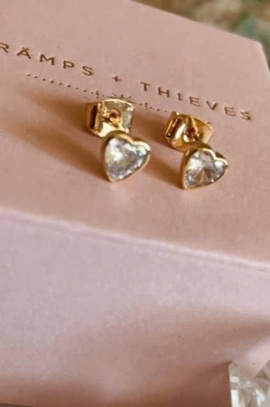 Crafted in Los Angeles, the Tramps+Thieves Hecate Studs feature 18K gold plating and shimmering clear CZ heart stones. A symbol of sophistication and luxury, these earrings offer an exclusive design for the discerning individual. Elegant Silver Heart Earrings, Gold Plated, Elegant Gold Plated Heart Earrings As Gift, Gold-plated Silver Heart Earrings Tarnish Resistant, Tarnish Resistant Silver Gold-plated Heart Earrings, Silver Gold-plated Tarnish-resistant Heart Earrings, Silver Tarnish-resistant Gold-plated Heart Earrings, Gold Cubic Zirconia Earrings With Heart Charm, Elegant Tarnish-resistant Gold-plated Heart Earrings, Elegant Gold-plated Tarnish Resistant Heart Earrings