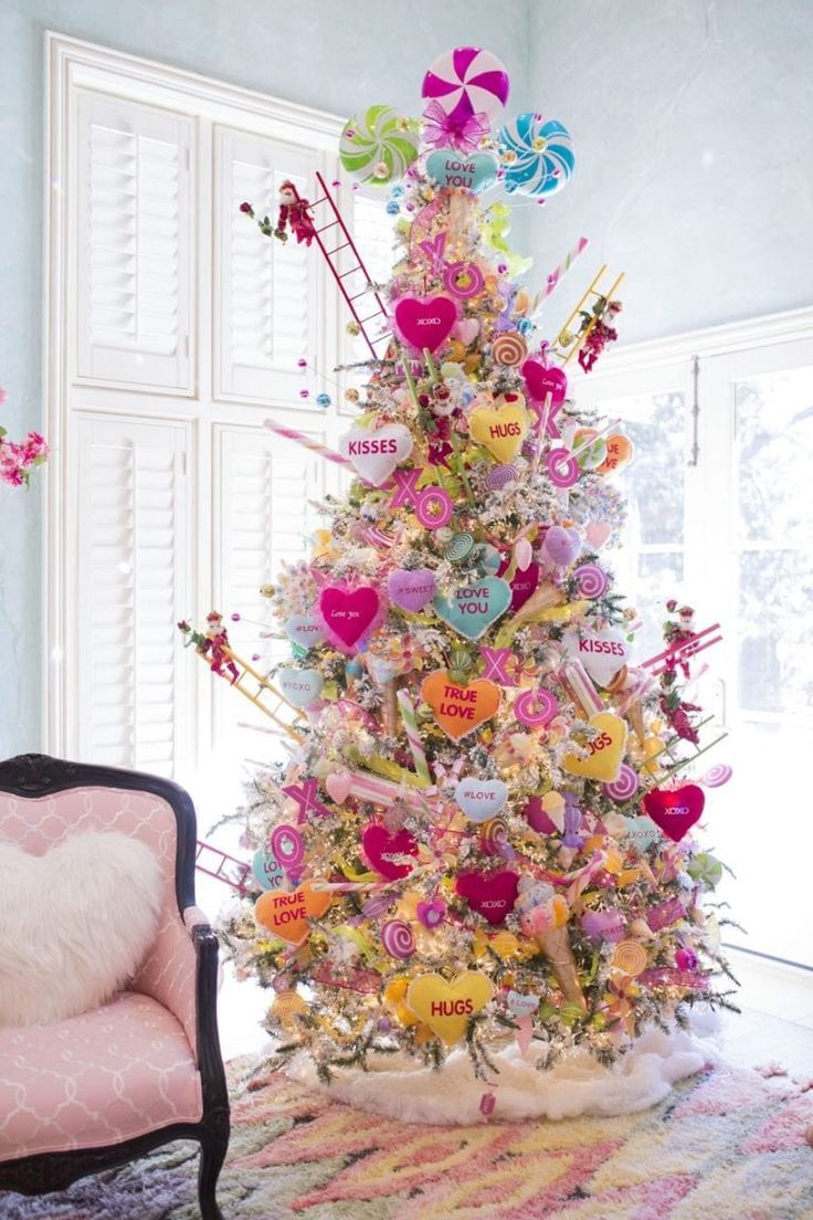 a brightly decorated christmas tree in a living room