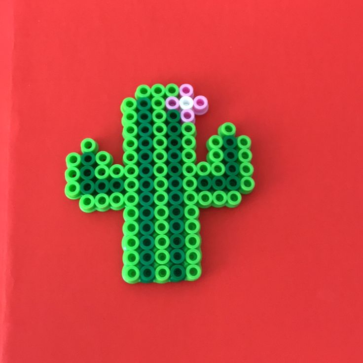 a cactus made out of legos on a red background