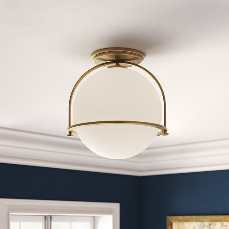 a ceiling light in a room with blue walls and white trim on the ceiling,