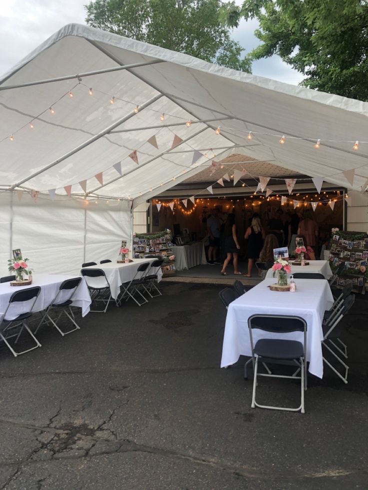 tables and chairs are set up under a tent