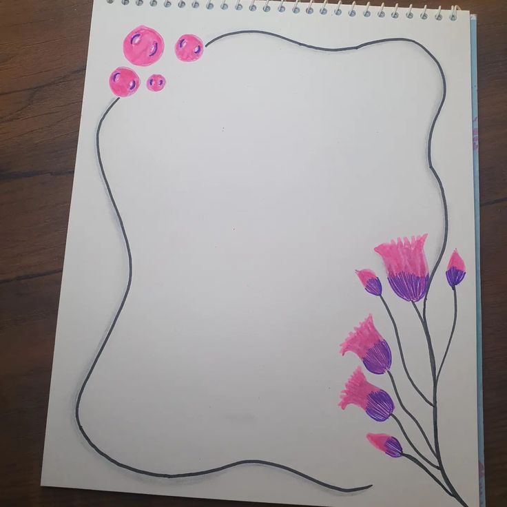 a notebook with buttons and flowers drawn on it