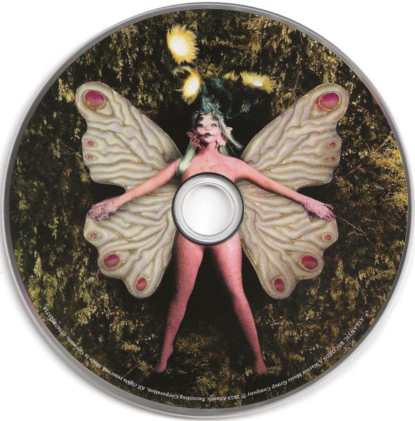 a cd with an image of a woman dressed as a butterfly on it's side