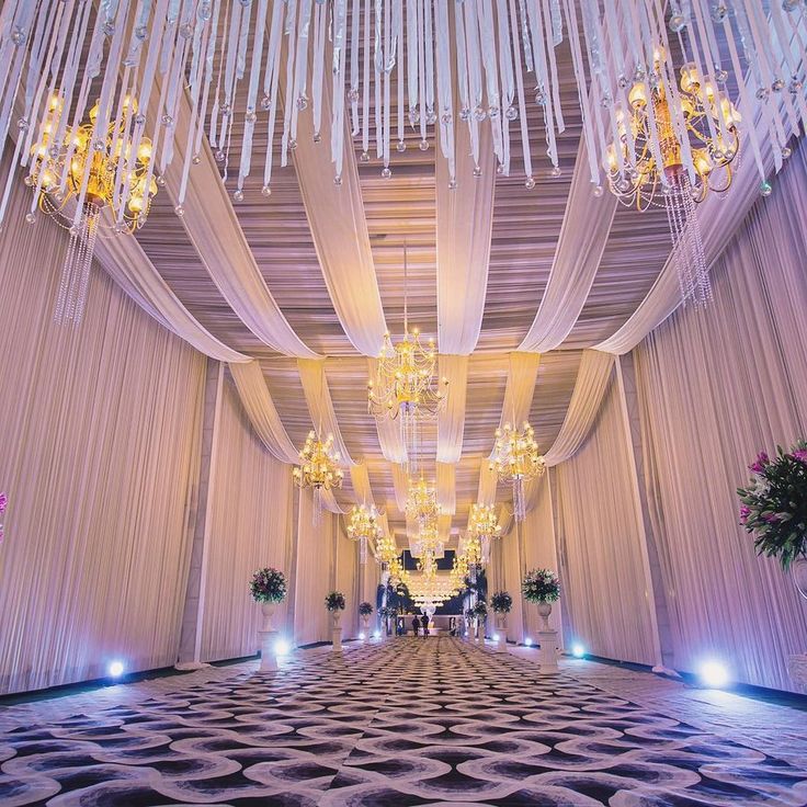 an elaborately decorated hall with chandeliers and lights