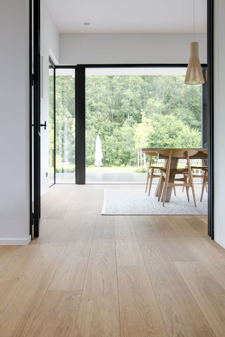 a dining room with wood floors and sliding glass doors